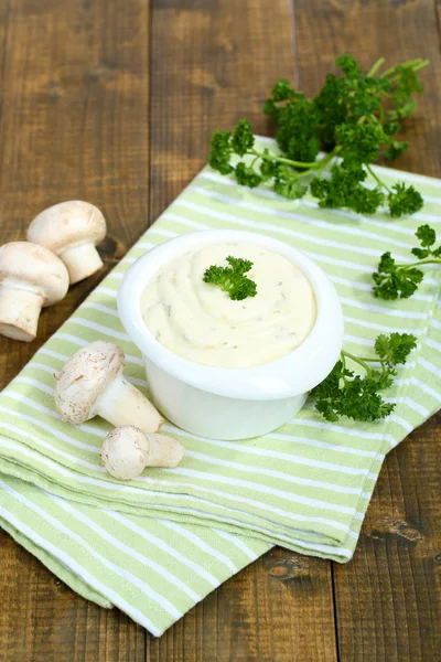 Delicate mushroom sauce in bowl on wooden table close-up — Stock Photo, Image