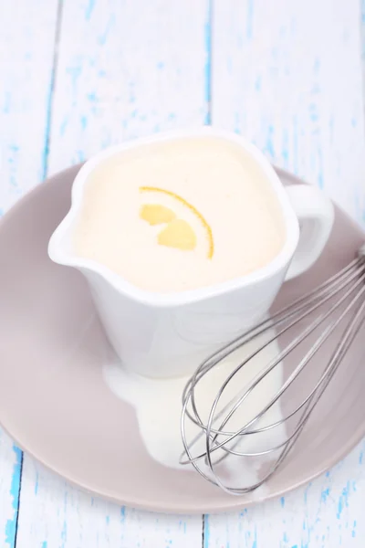 Delicate sauce in pitcher on wooden table close-up — Stock Photo, Image