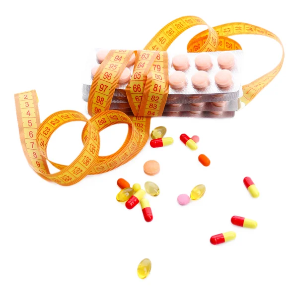 Measuring tape and pills, isolated on white. Dieting concept — Stock Photo, Image