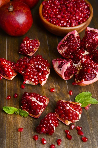 Ripe pomegranates on table close-up — Stock Photo, Image