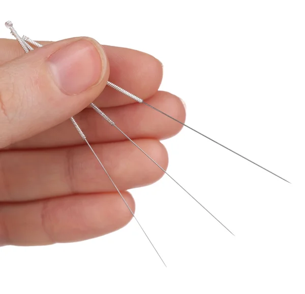 Hand holding needles for acupuncture on hand, close up. Isolated on white — Stock Photo, Image