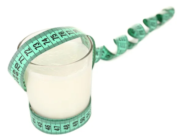 Glass of milk with measuring tape isolated on white — Stock Photo, Image