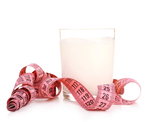 Glass of milk with measuring tape isolated on white — Stock Photo, Image