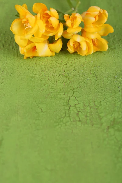 Beautiful freesias on wooden table — Stock Photo, Image