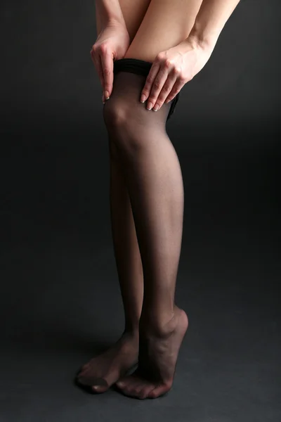 Stockings on perfect woman legs on dark background — Stock Photo, Image
