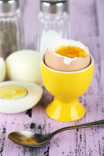 Boiled eggs on color wooden background — Stock Photo, Image