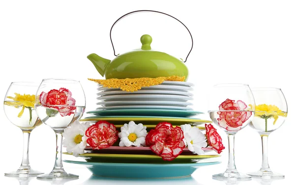 Stack of colorful ceramic dishes and flowers, isolated on white — Stock Photo, Image