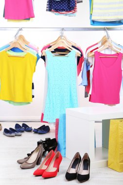 farklı elbise askıları ve açık renkli ayakkabıları