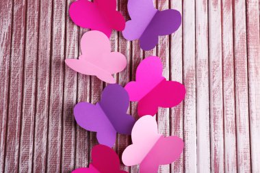 Kağıt ahşap zemin üzerinde kelebekler kesmek