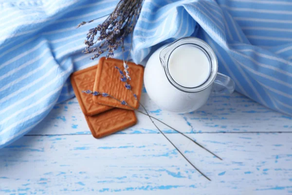 Homemade yogurt in jug and tasty cookie on wooden table background — Stock Photo, Image