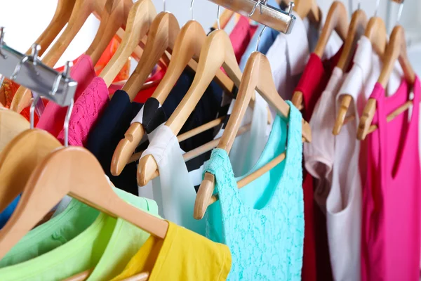 Different clothes on hangers close up — Stock Photo, Image