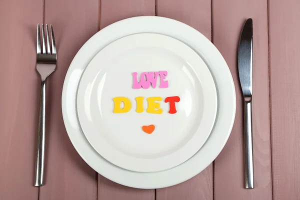 Plate with inscription love diet on wooden table close-up — Stock Photo, Image