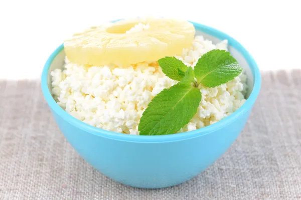 Bowl of tasty cottage cheese with pineapple, isolated on white — Stock Photo, Image