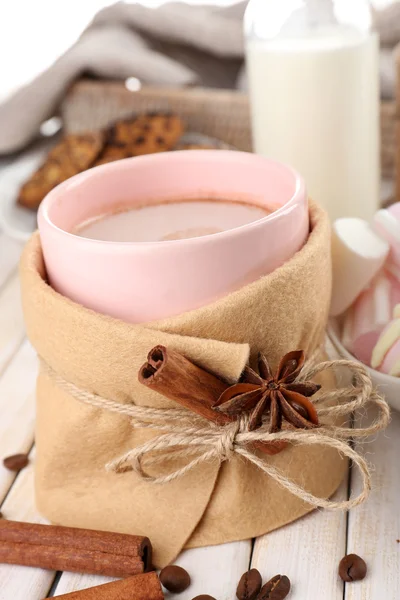 Mug of hot drink decorated in felt on wooden table — Stock Photo, Image