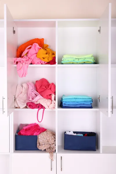 White shelves with colored clothing close up — Stock Photo, Image