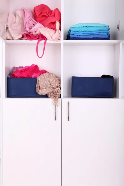 White shelves with colored clothing close up — Stock Photo, Image