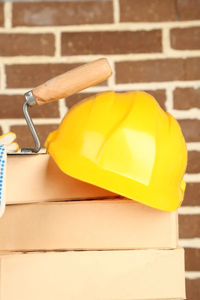 New bricks and building tools on brick wall background — Stock Photo, Image