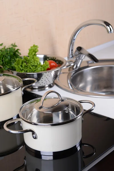 Pots on stove in kitchen — Stock Photo, Image