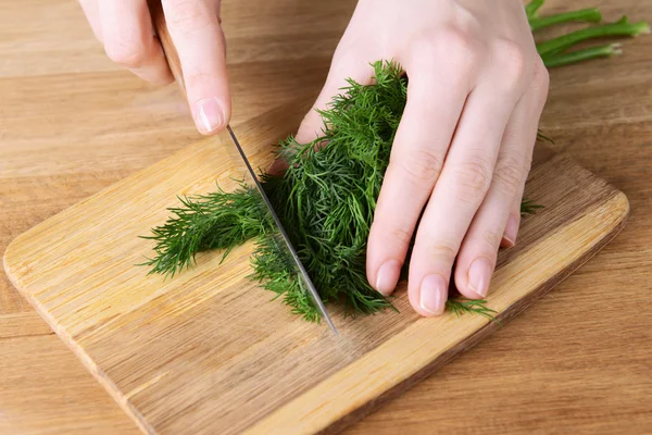 Chopped dill on wooden board close-up — Stock Photo, Image