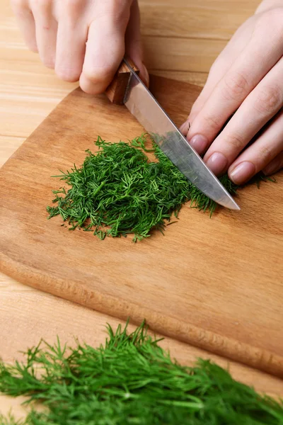 Chopped dill on wooden board close-up — Stock Photo, Image