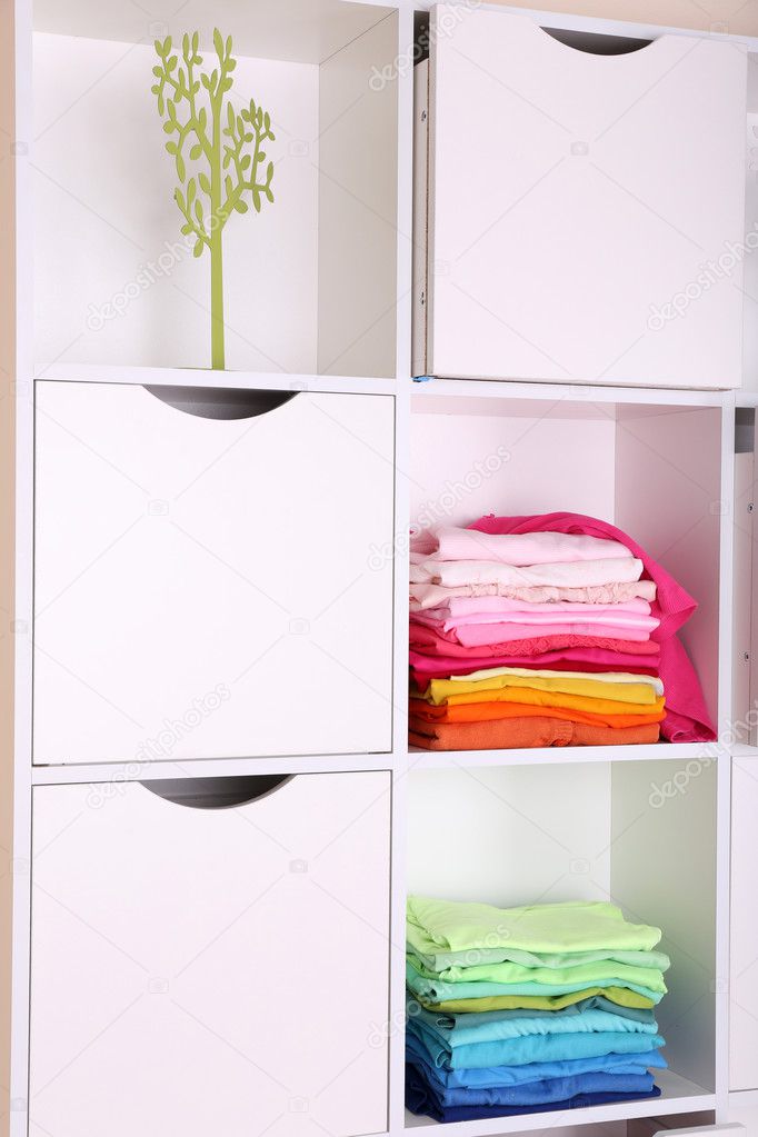 White shelves with colored clothing close up