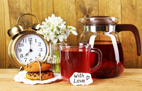 Tasty herbal tea and cookies on wooden table — Stock Photo, Image