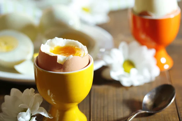 Boiled eggs on color wooden background — Stock Photo, Image