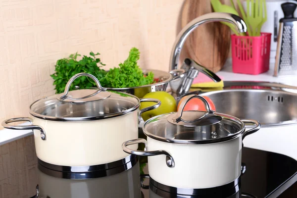 Pots on stove in kitchen — Stock Photo, Image