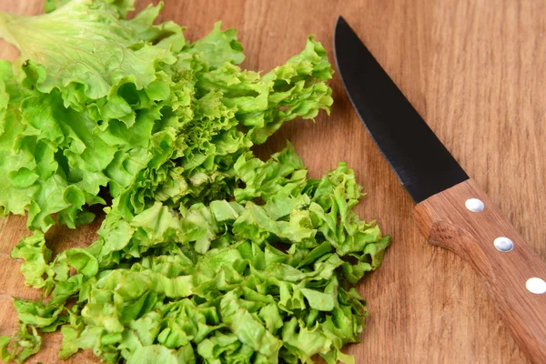 Chopped green lettuce  on wooden board close-up — Stock Photo, Image