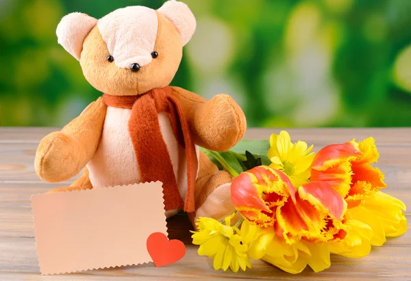 Bear toy on table on bright background — Stock Photo, Image