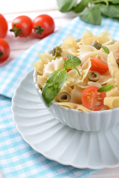 Delicious pasta with tomatoes on plate on table close-up — Stock Photo, Image