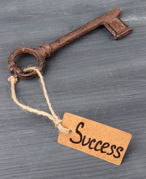 Key to success, Conceptual photo. On color wooden background