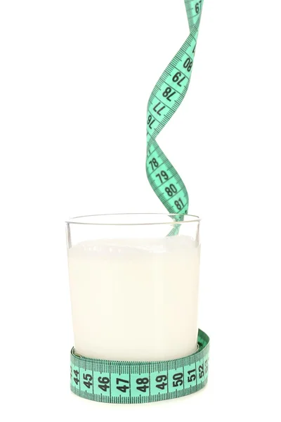 Glass of milk with measuring tape isolated on white — Stock Photo, Image