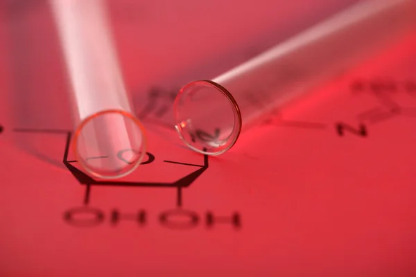 Test tubes and reaction formula, close-up — Stock Photo, Image