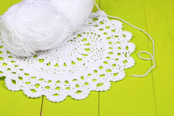 White yarn for knitting with napkin and spokes on wooden table close-up — Stock Photo, Image
