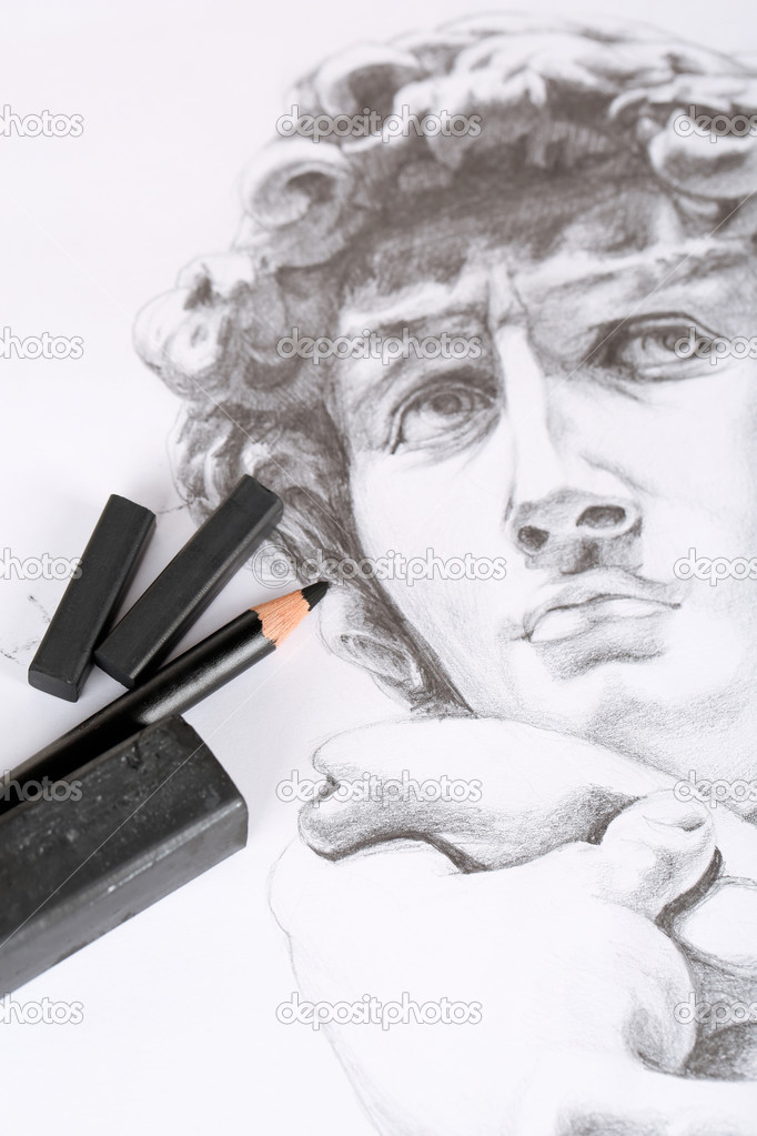 Black drawing charcoals and pencil on picture isolated on white
