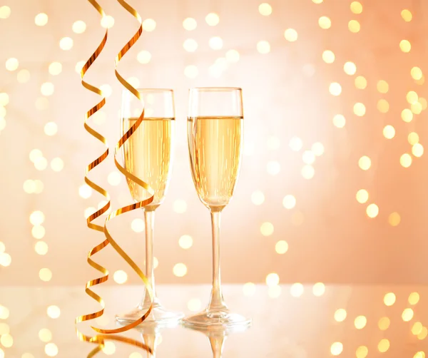 Glasses of champagne on shiny background — Stock Photo, Image