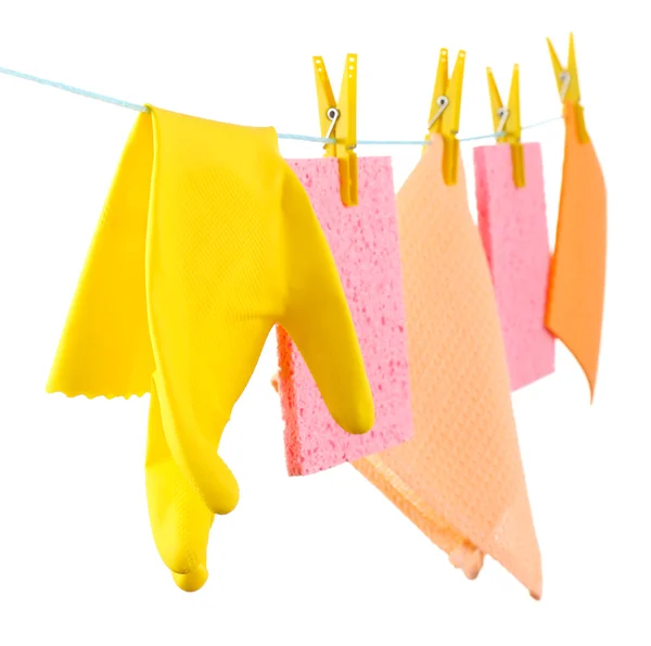 Kitchen sponges and rubber gloves hanging on rope isolated on white — Stock Photo, Image