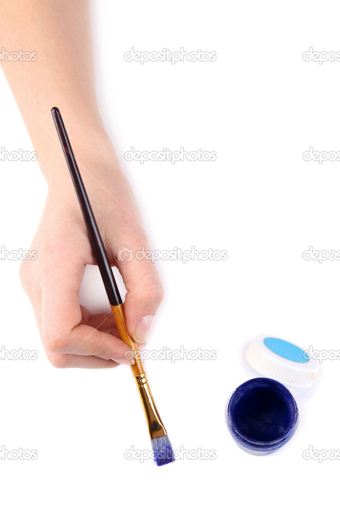 Hand holding brush with blue paint isolated on white
