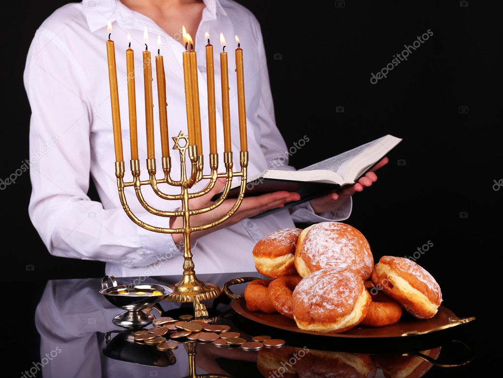 Festive ceremony on Hanukkah on dark background