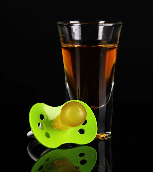 Baby dummy with alcoholic beverage isolated on black — Stock Photo, Image
