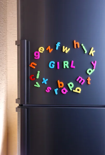 Word Girl spelled out using colorful magnetic letters on refrigerator — Stock Photo, Image