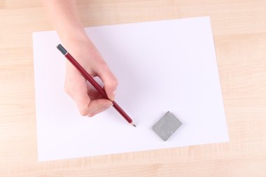 eli kalem tutan ve Kağıt ahşap zemin ile silme