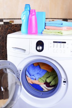 Washing machine loaded with clothes close-up clipart