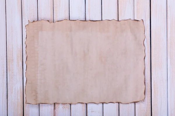 Old paper on wooden background — Stock Photo, Image