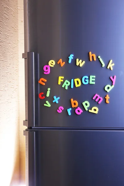 Word Fridge spelled out using colorful magnetic letters on refrigerator — Stock Photo, Image