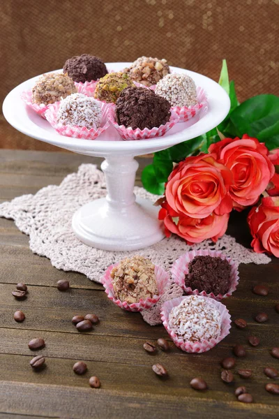 Set of chocolate candies on table on brown background — Stock Photo, Image