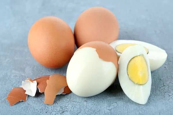 Boiled eggs on color wooden background — Stock Photo, Image