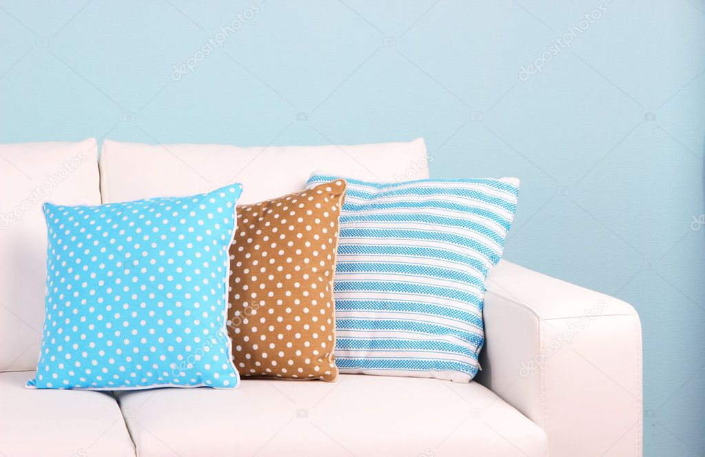 White sofa close-up in room on blue background