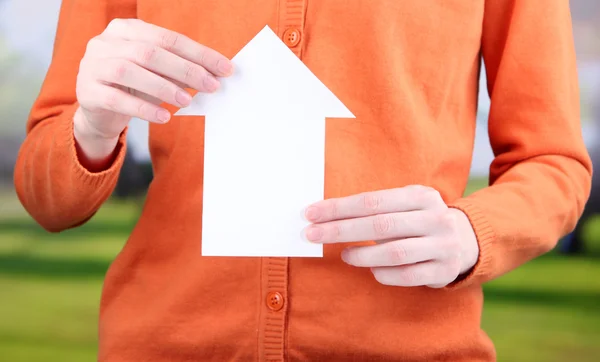 Little paper house in hand close-up, on bright background — Stock Photo, Image